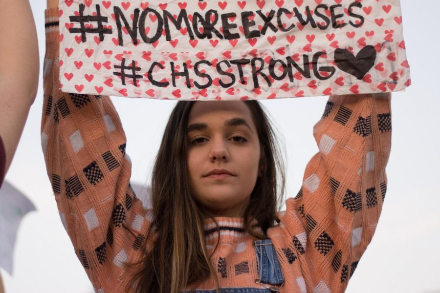 Wandi Alum Morgan Pace displays a sign expressing support for the victims of the Marjory Stoneman Douglas High School.
