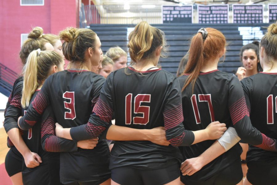 Wando Volleyball locks arms during an Invitational that Wando hosted.