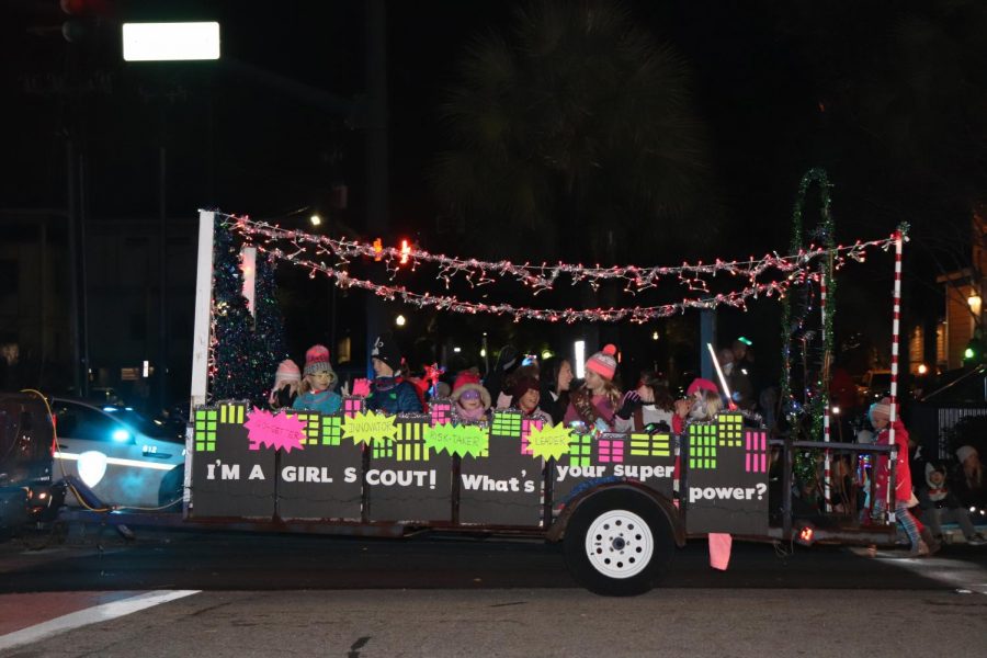 The Girl Scouts travel down Coleman Blvd, showing off their Christmas spirit.