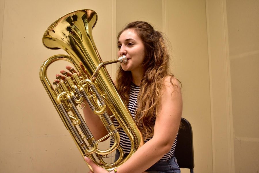 Camila Dorst playing a euphonium. 