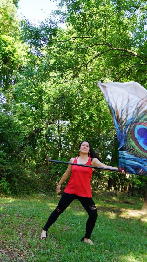 Grace Jaroscak performing a color guard routine.