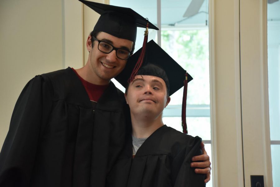 The+Carlin+brothers+pose+in+their+graduation+attire.