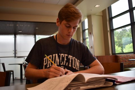 Jack Johnson prepares for his AP exams while sporting a shirt representing his future college. 