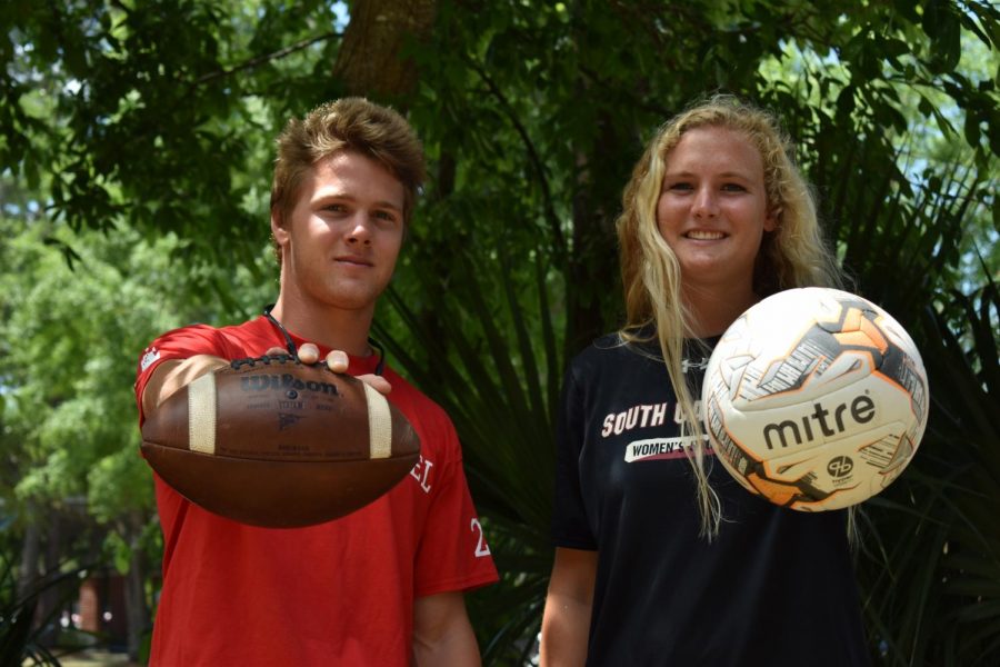 Sami and Huw Merideth hold a football and a soccer ball showing the unique sports they have mastered.