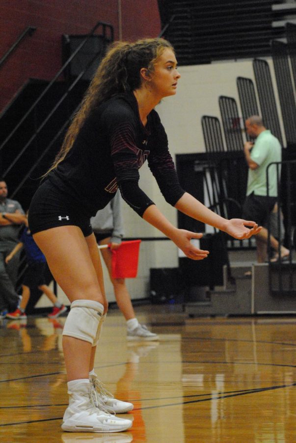 Senior Grae Gosnell preparing to hit back volleyball back to the opposing team. 