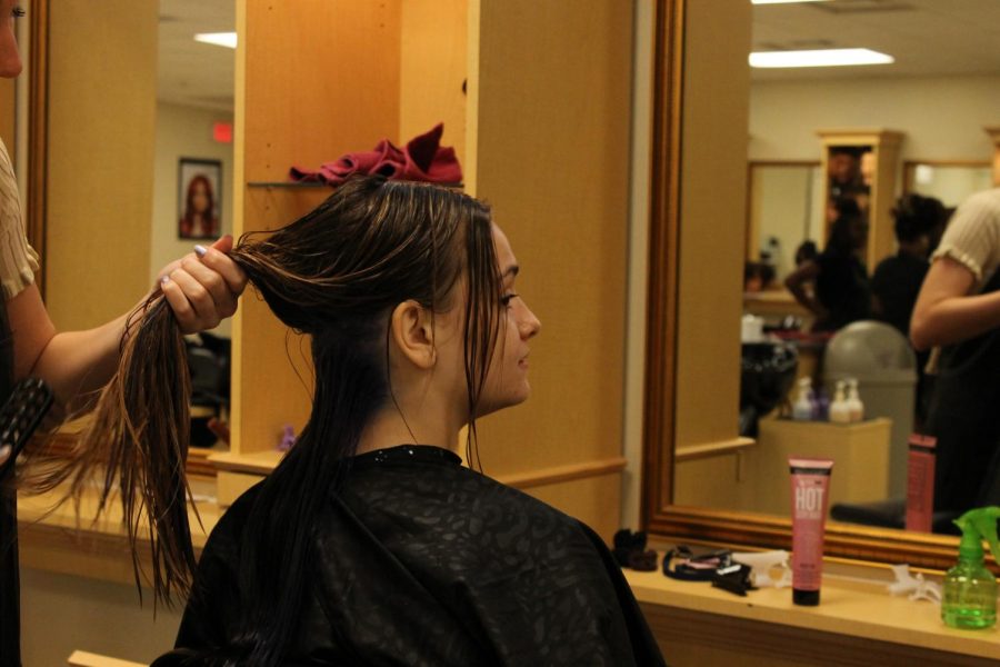 Junior Lindsey Hepburn gets her hair dyed in the Wando High School cosmetology classroom.