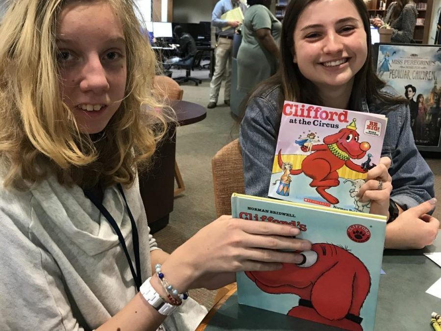 Senior Lauren Nix (right) poses with a book. 