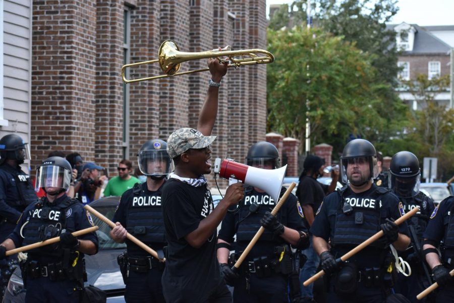Through the use of emotional speeches, Marcus McDonald captured the importance of why he protests and why change is needed. He raises his trumpet as a sign that he will not be silenced.