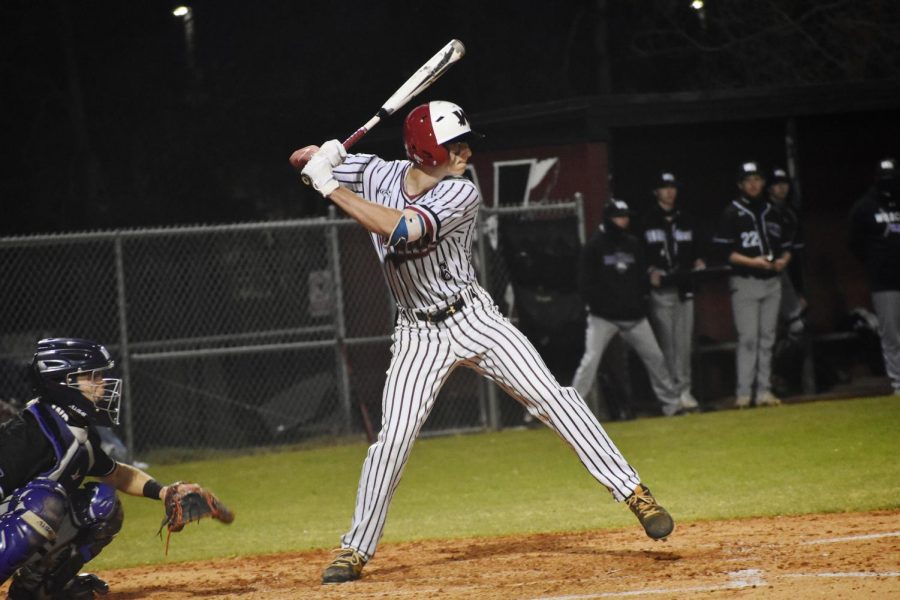 Mac Ketchen raises his arms back behind his head as he prepares to swing. 