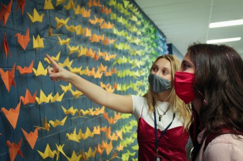 Juniors Alli Ryan and Bailey Young admire the artwork of Bratcher’s students during their lunch period.
