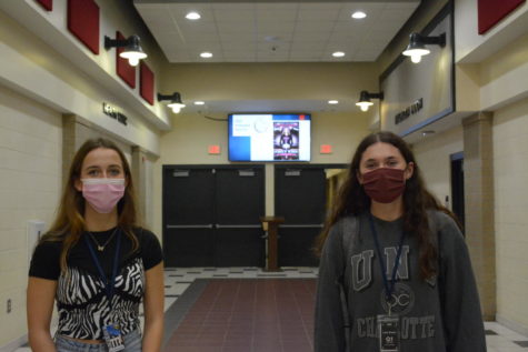 Juniors Ava Shoonerover (right) and Leia Eilsen (left) demonstrate Wandos new mask requirement in the building.