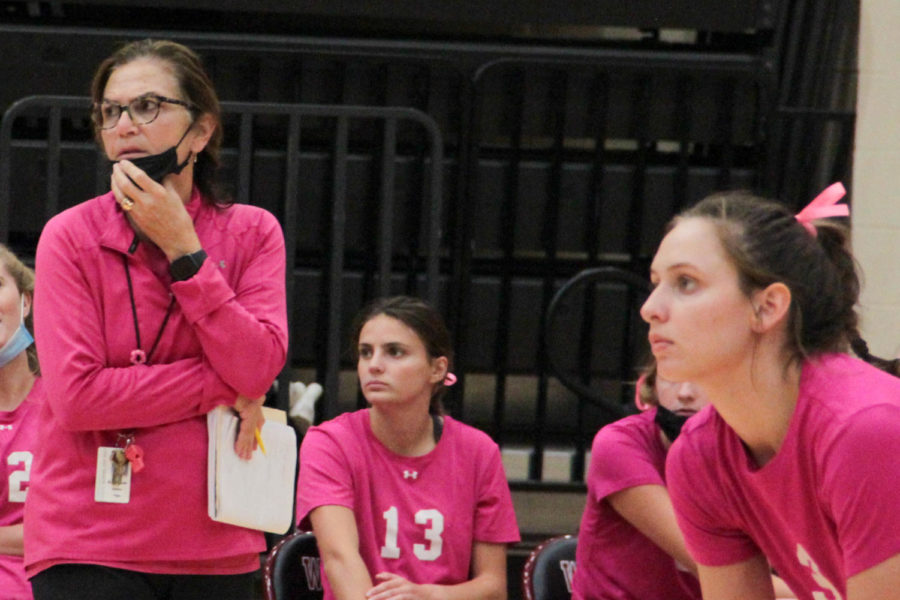Coach Alexis Glover and Senior Addie Castle watching the other team as Senior Emily King gets ready to play.

