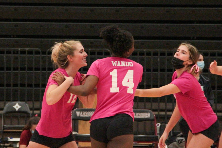 Senior Taylor Feher, Junior Aurie Fisher, and Junior Mackenzie Rowan congratulating each other on winning their set.
