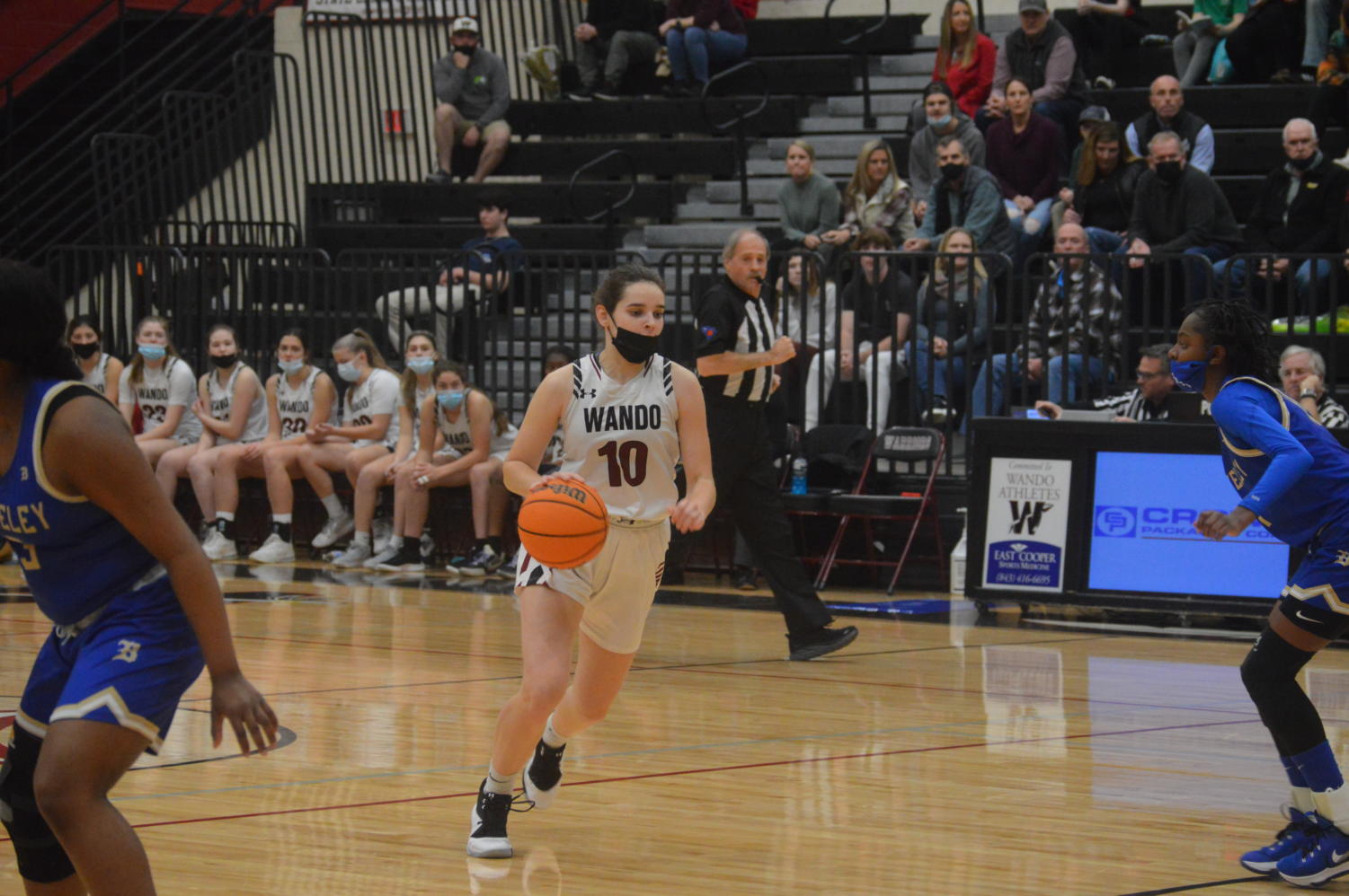 Senior Grace Waite dribbling the ball up the court while her opponent is coming to defend her.
