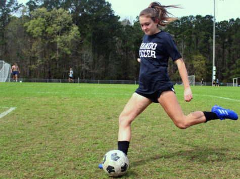 Sophomore Ansley Douty practices soccer on a beautiful day, which is one of her favorite activites. She focuses then kicks the ball into the goal flawlessly.
