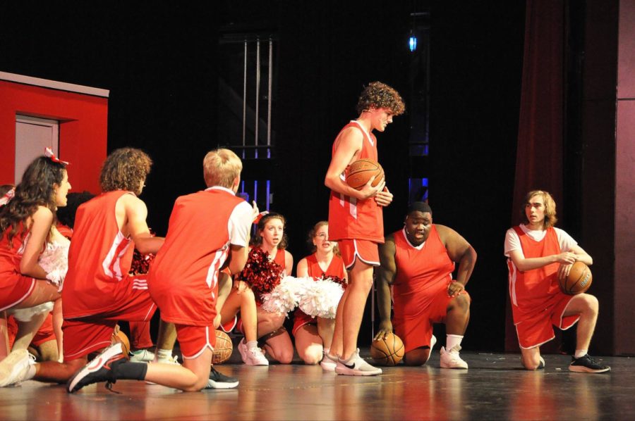 The jocks are on their knees harmonizing as Troy Bolton prepares for his leading solo in Getcha Head in the Game.
