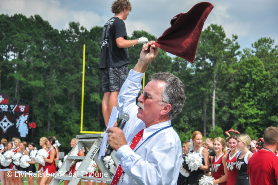 Wando's new principal, Kim Wilson, shows school spirit at the pep rally by swinging around the rally towels given to each student.