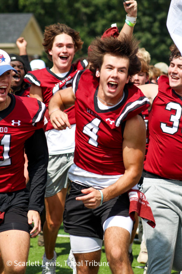 Senior Ryan Carrafiello screams as he leads the football team onto the field at Wando’s first pep rally of the year. 
