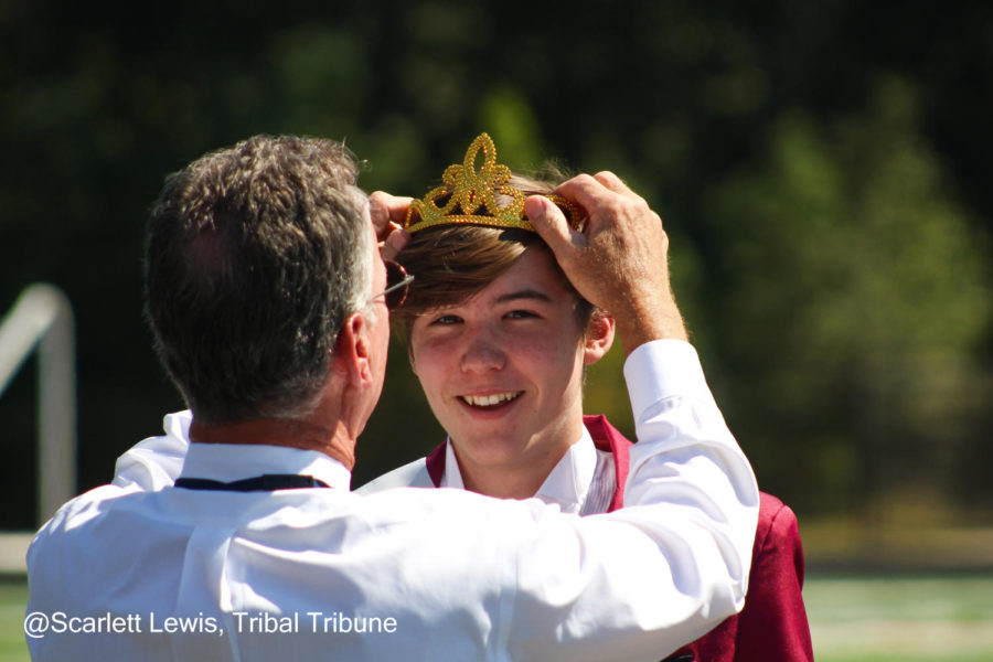 Principal Wilson crowns Freshman Ender Kellner the homecoming knight. Ender smiles with joy.