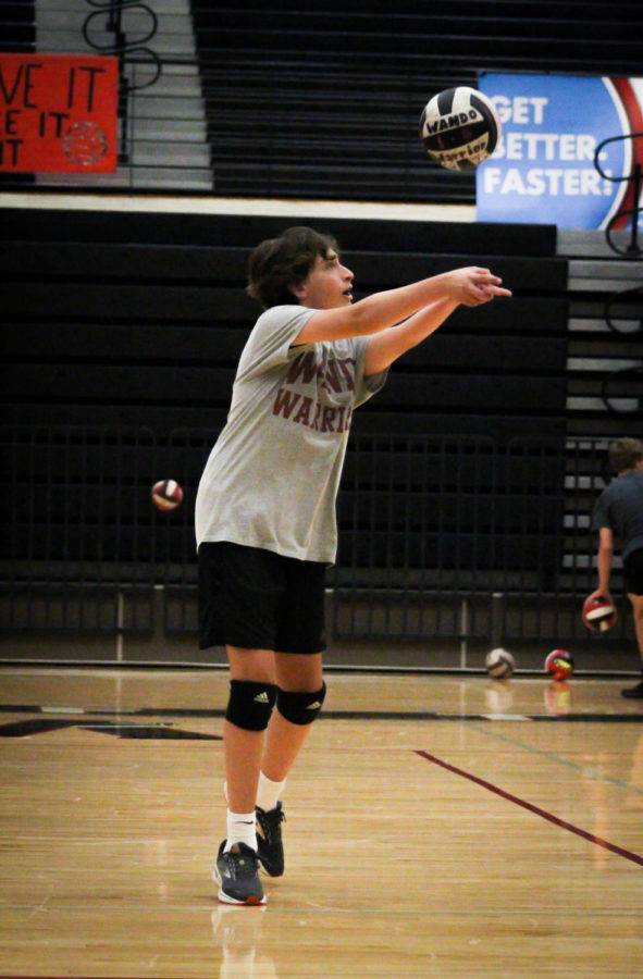 Freshman%2C+Callan+Potter%2C+during+practice%2C+passes+the+vollyball+to+his+teamate+during+a+warmup.