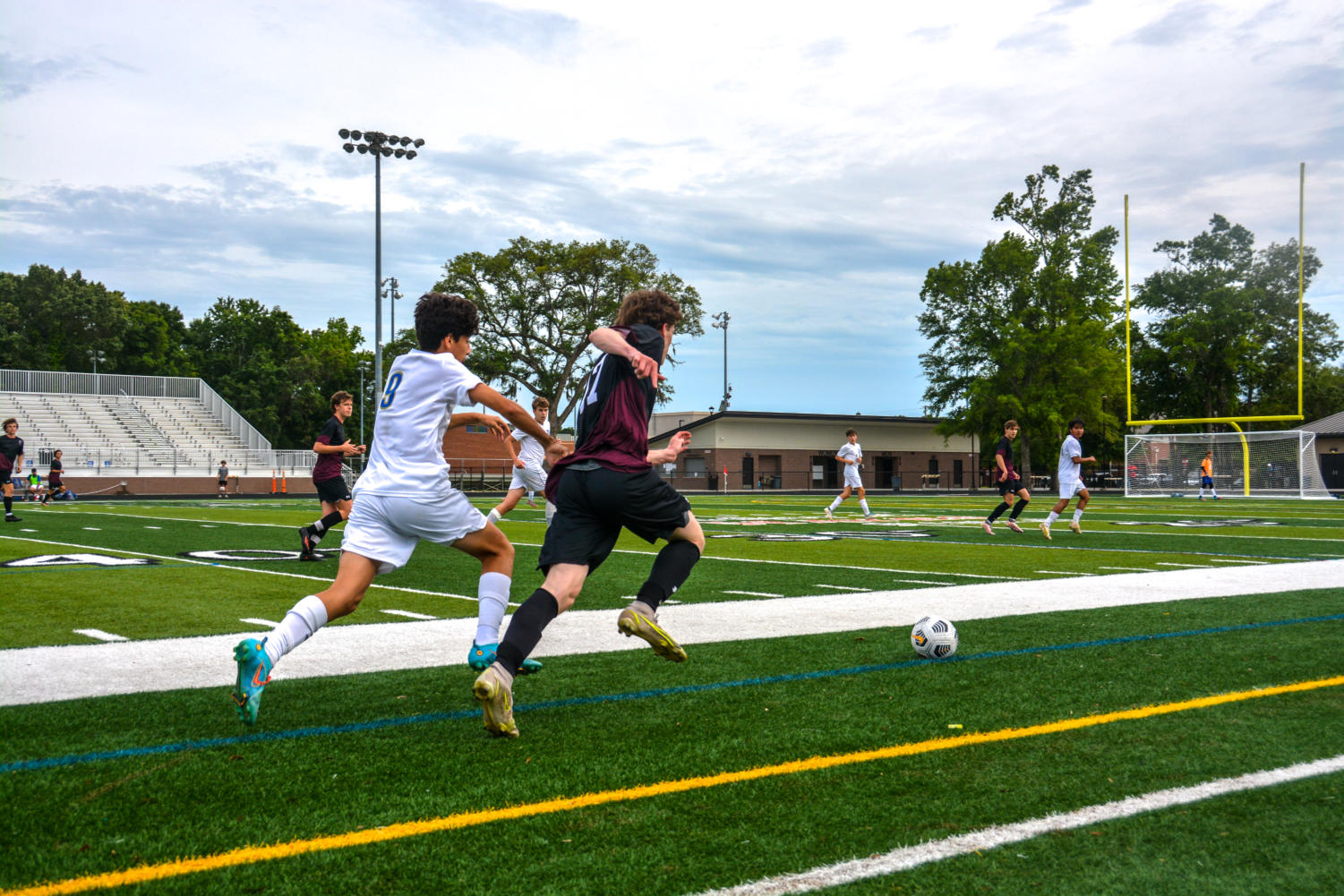 Senior Shane Zins runs after the soccer ball, trying to get it before his opponent.