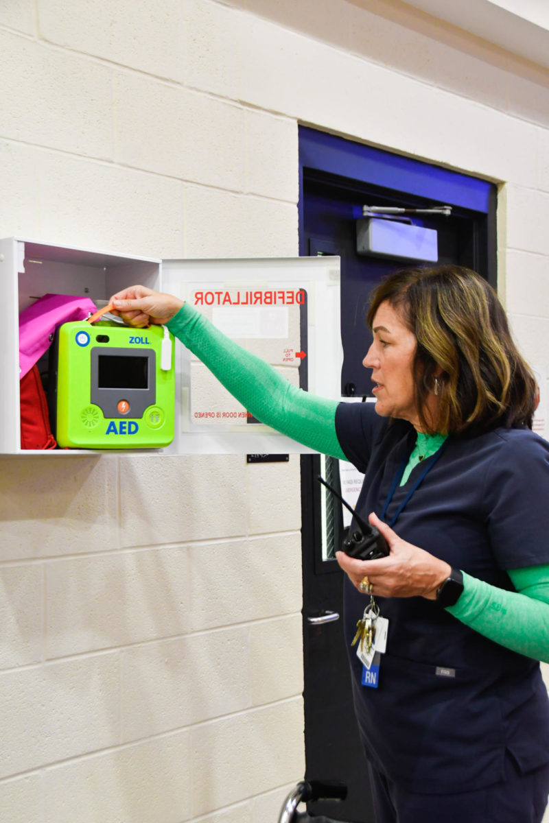 Nurse Elizabeth Bumgarner removes the automated external defibrillator during a case of emergency.