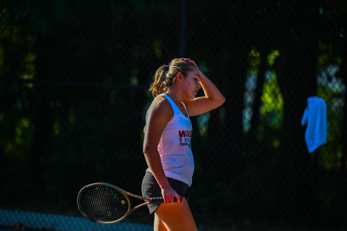 Junior Jenna Zimmerman walks away defeated after her opponent wins a point.