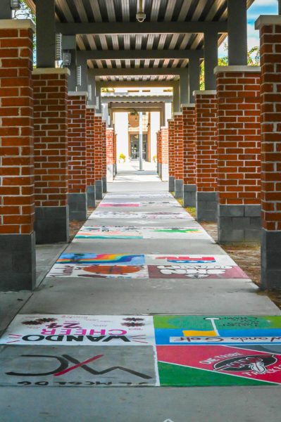 Students work together painting a walkway on Oct 13 as part of a new tradition to represent clubs, organizations, and classes with banners and other simple paintings such as inspirational quotes