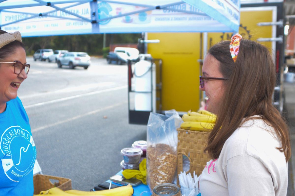 Sophomore Madison Isenhour orders an acai bowl during the celebration of the One Tribe campaign. PTSO president Arianna Solinger helped run the One Tribe fundraiser this year. “We brought in food trucks, and we hired a DJ, to... celebrate with the students,” Solinger said.