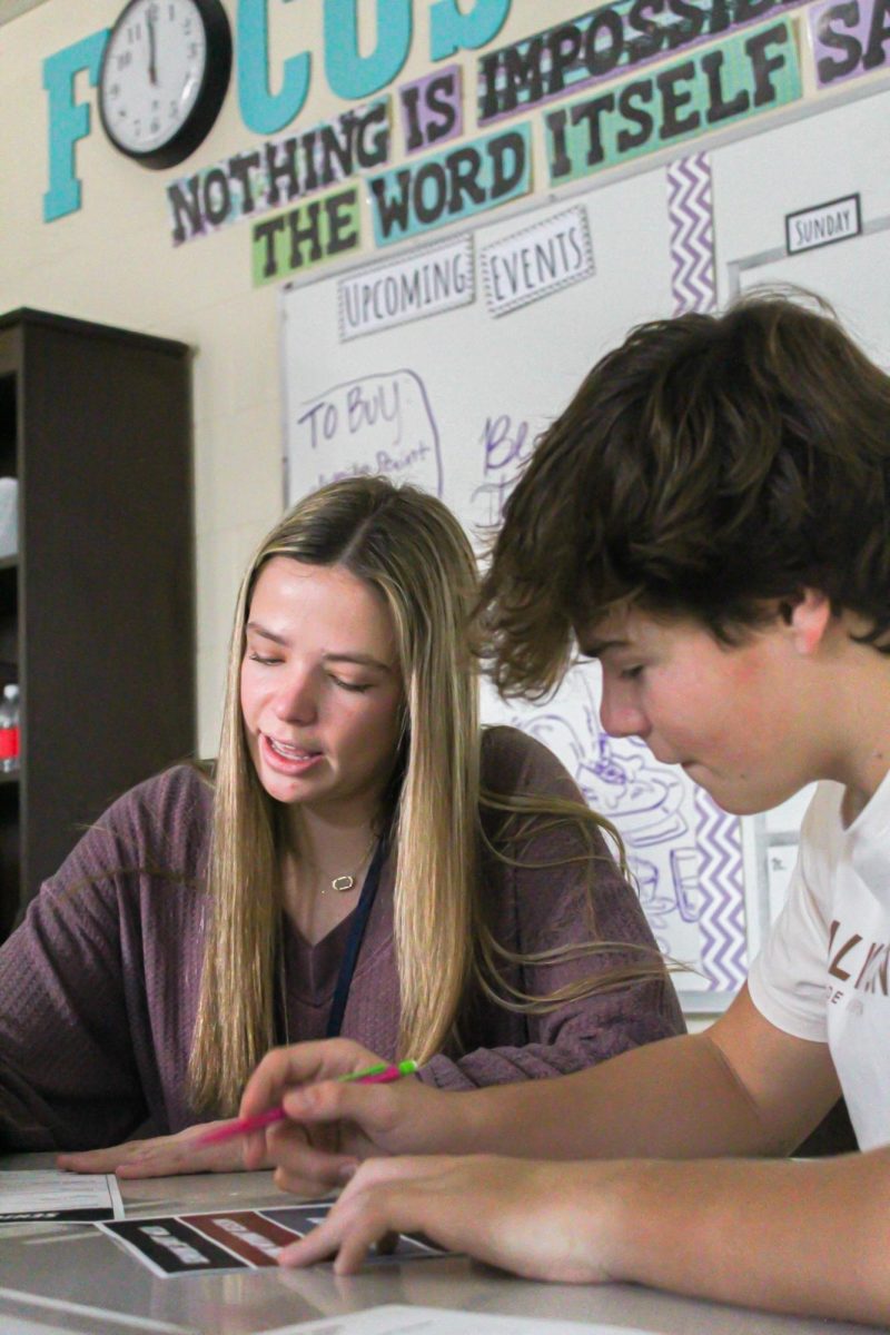 Senior Madeline Capps and freshman Bryce Capps work together on the 
PowderPuff tournament plans. “We get to support each other and help each 
other out,” Madeline said.