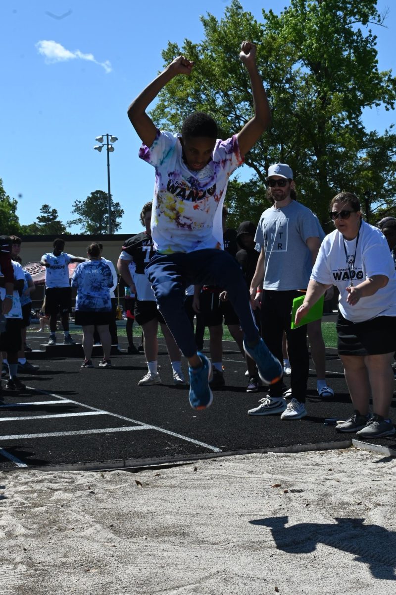 Special Olympics athlete Sammy Yohannes 
leaps during the long jump competition. 
“[I was] happy… big smile,” Yohannes said.