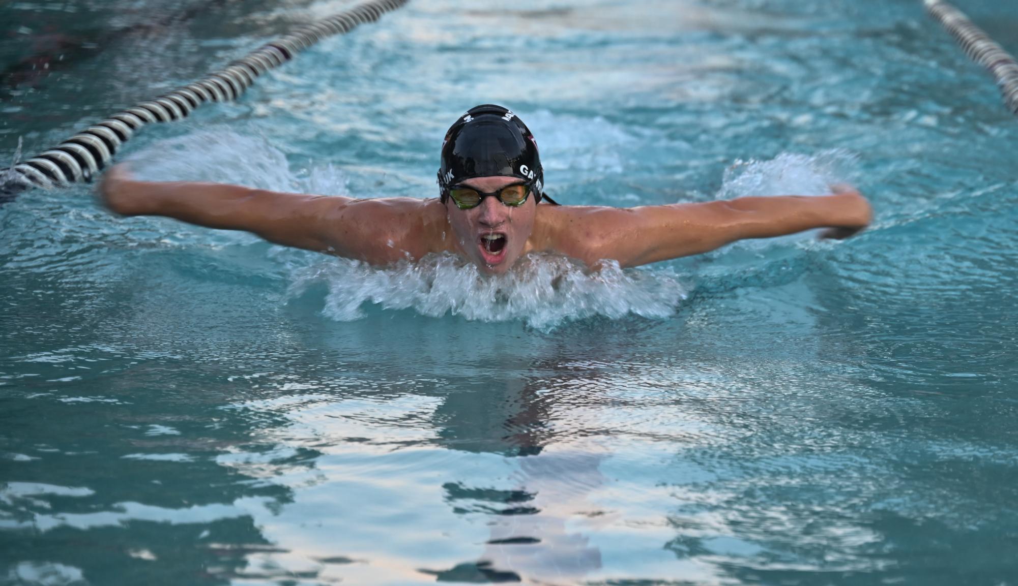 Senior Ethan Gawryluk gasping for a breath of air while swimming butterfly