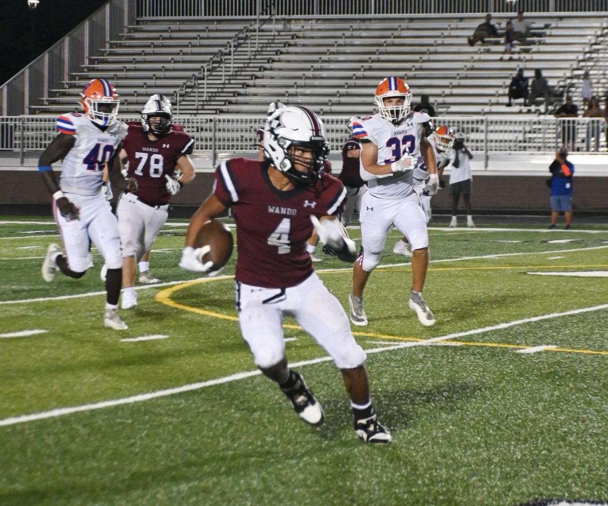 A warrior football player makes a big play on the field.