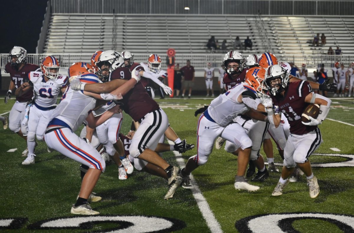 Wando offensive linemen block for their runningback.