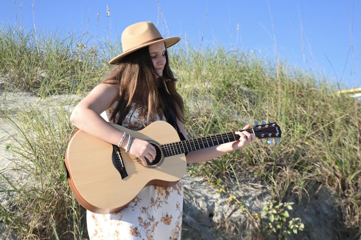 Junior Rebekah Faith Appleton plays her guitar on the beaches of Isle of Palms. “I really like the sound of guitar...it’s also one of those things that are so rewarding.”