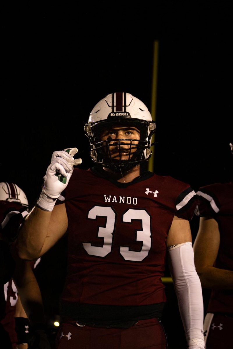 Senior Linebacker Brock Feinburg walks onto the sideline after a defensive stop.