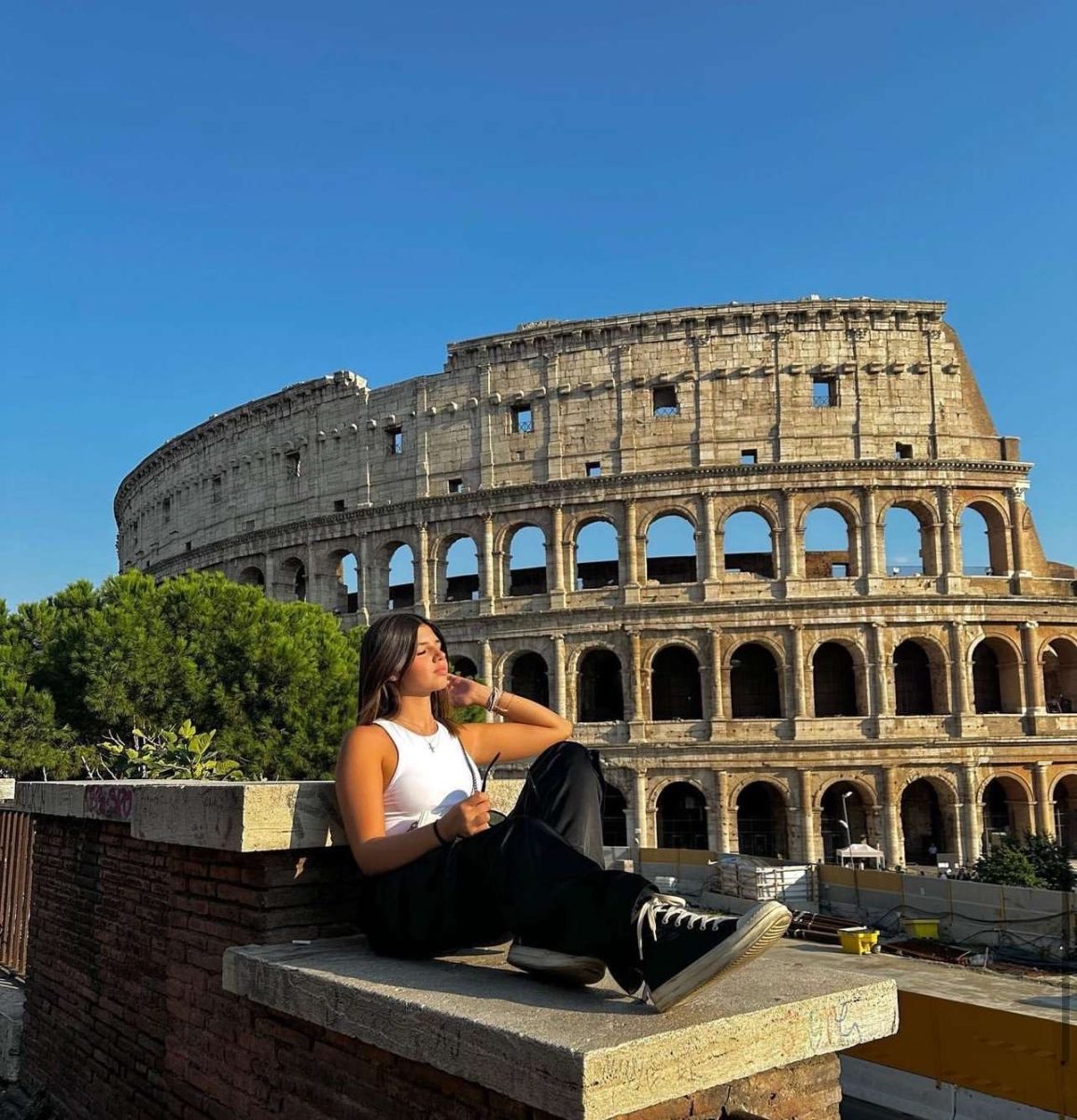 Junior Fabiana Stella Poses in front of the Coliseum, a popular tourist attraction in her home country of Italy. "You [United States] don't have metros; we go everywhere here on foot," Stella said. 