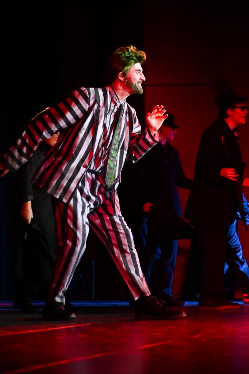 Beetlejuice played by Senior Jeremy Rokos flashes a wide smile during one of the many beginning performances. 