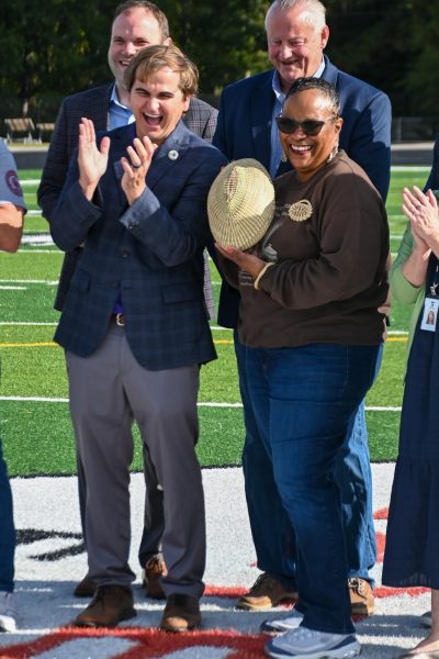 The mayor stands with the trophy during the media photoshoot.