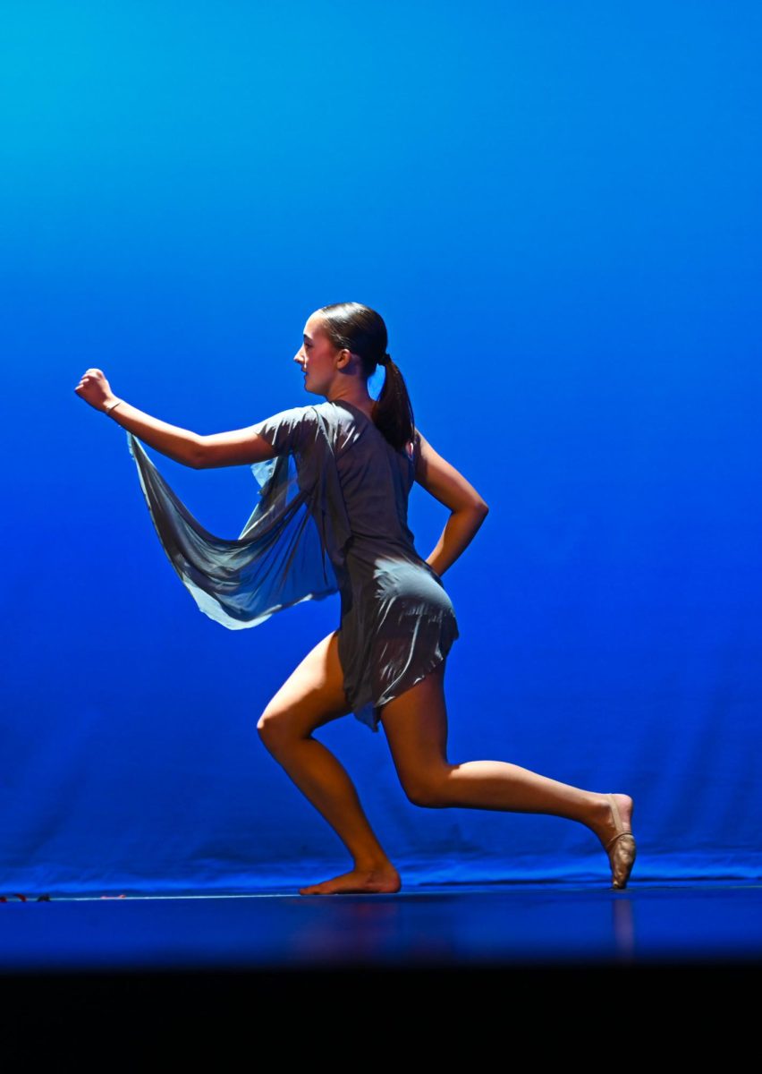 Sophomore Ginny-Kate Caslon stands alone on stage before the preformance.