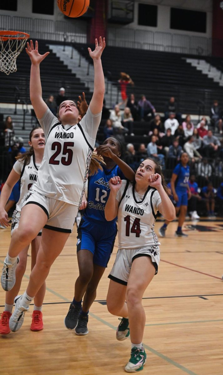  Junior Guard Caroline Bowers helps her teammates to get a rebound. “I was looking for the ball, I was really focused on getting there [the basket],” said Bowers 