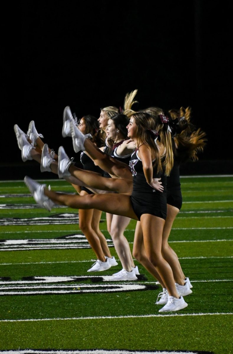 During a Halftime performance the dance team creates a kick line 