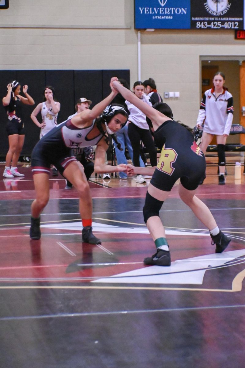 Senior Cassidy Warren wrestles against Ashley Ridge High School. "[It] was a good match and it's exciting because we hadn't really had... an all girls match only, so it was fun to be a part of one of the first all girl matches... It's hard to get matches as a girl in South Carolina. It's worth practicing for," Warren said.