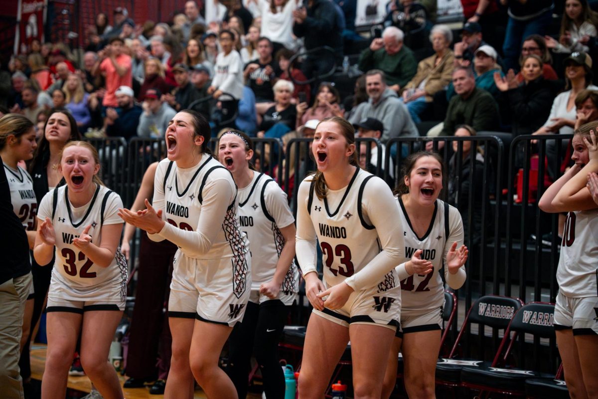 Senior Forward Mya Andrus and her teammates shout in excitement after a major play in the final seconds of the game.