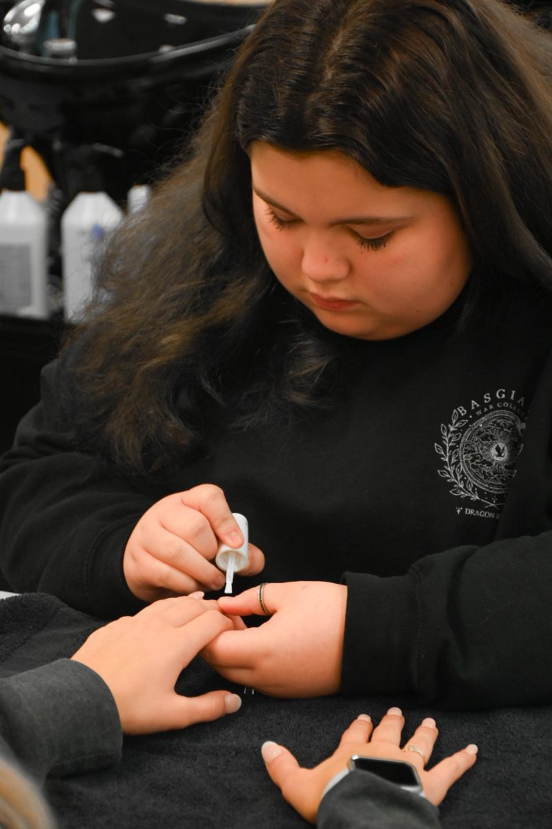 Senior Haley Robertson works diligently painting nails and learning the passion she loves. “I don’t think I will ever fall out of love with  the craft,” said Robertson.