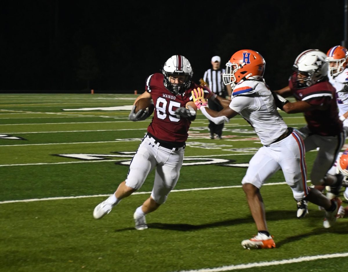 Sophomore Cannon DeMoura fights for more yardage after a catch vs. Hanahan in August. DeMoura, a multi-sport athlete, has battled concussion injuries in the past. “It’s pretty sad. I mean, like, I had to start 
the season off with a concussion and I couldn’t even play the first game,” DeMoura said.