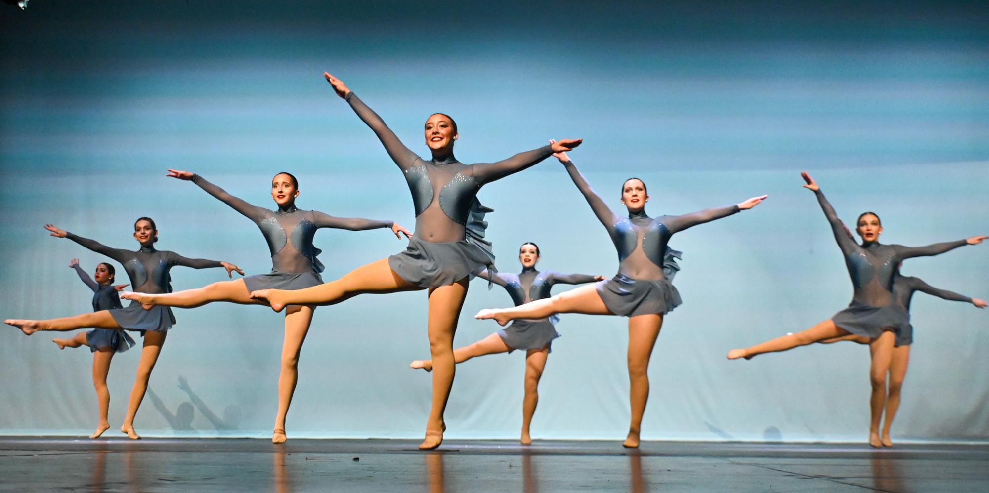 Sophomores Adalyn Calhoun Ginny Cason twirl in formation with the other dancers.