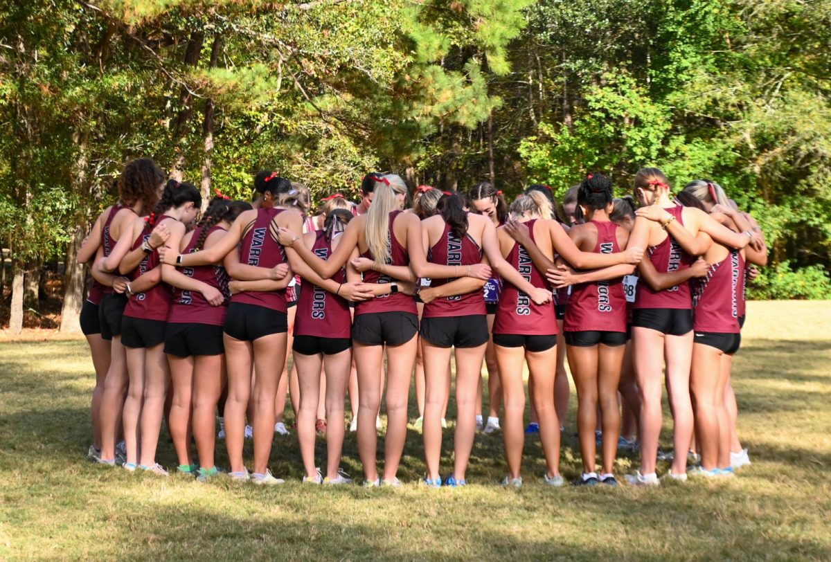 Runners huddle together before race.