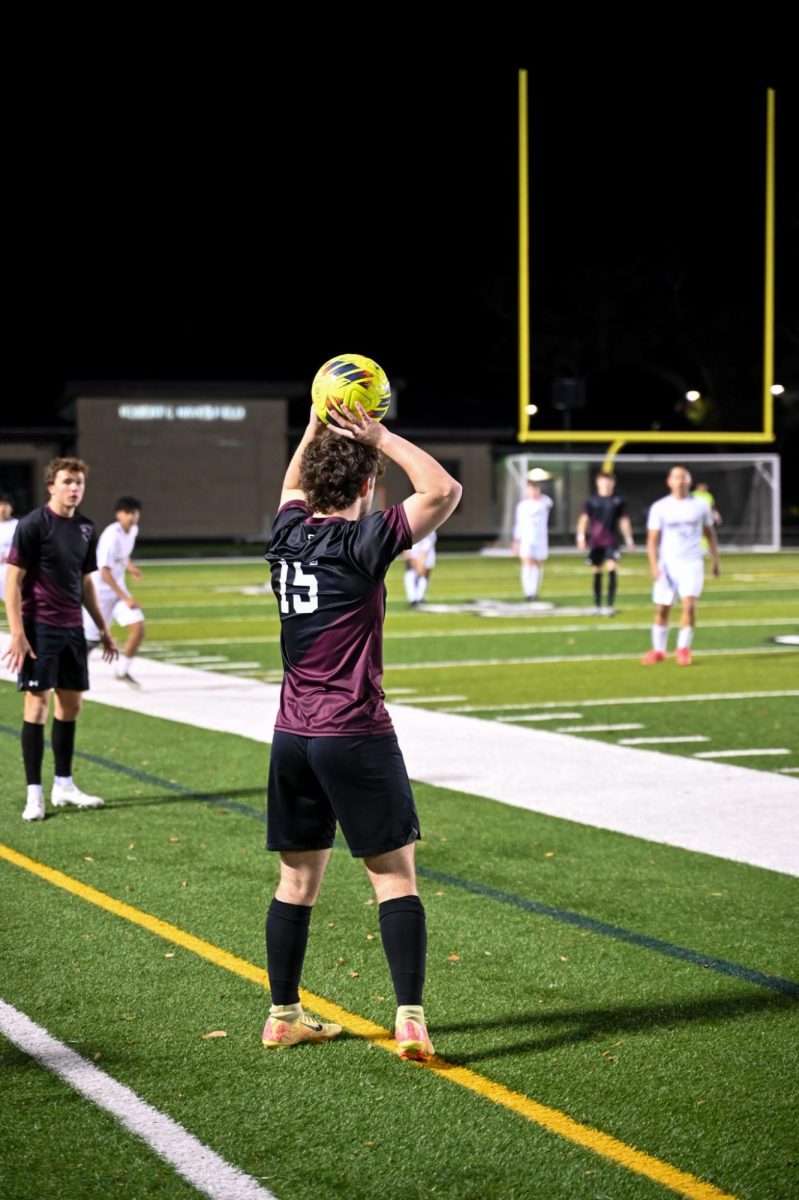 Junior Greyson Biggs goes to throw in the ball from out of bounds 