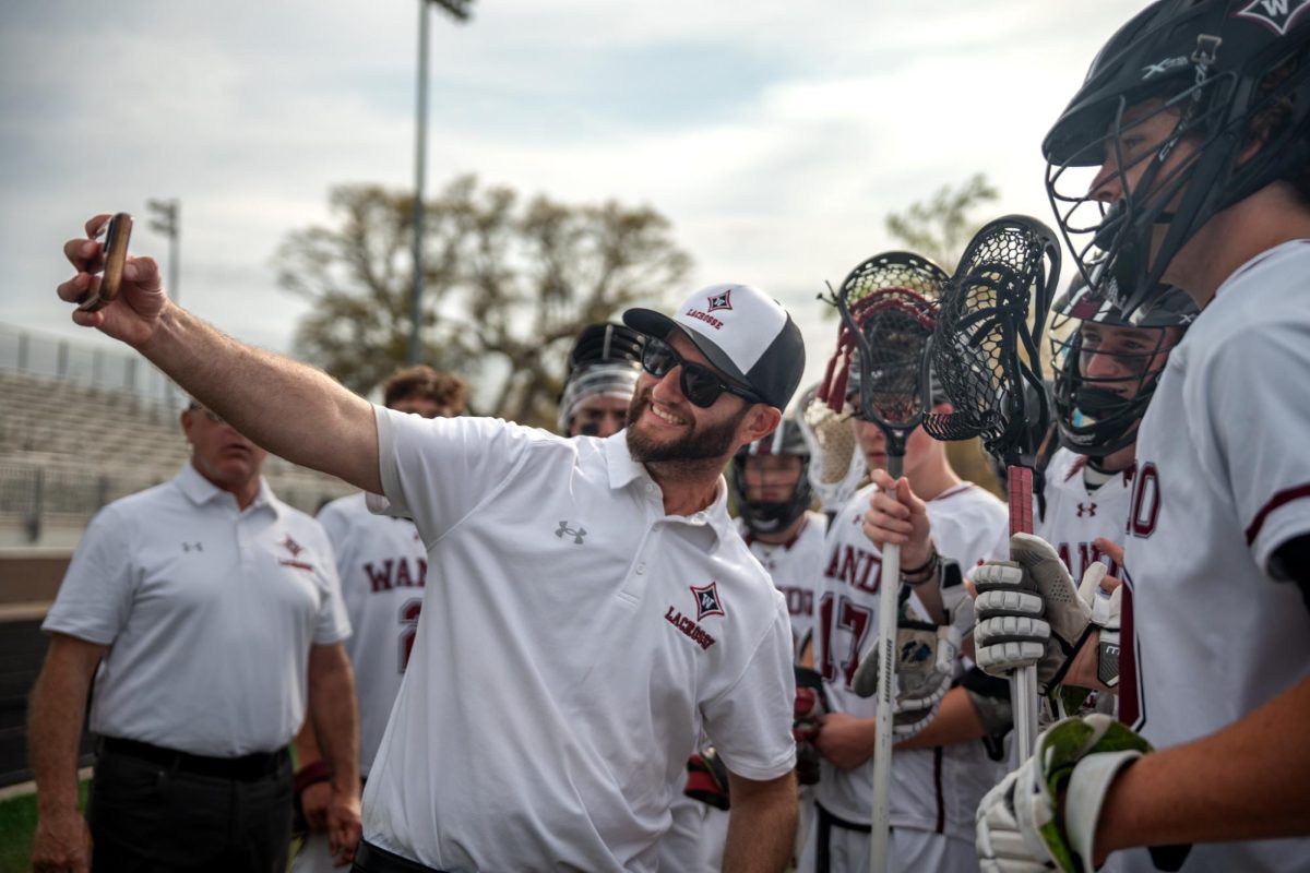 Head coach Lance Renes takes a celebratory selfie with the team after the win.